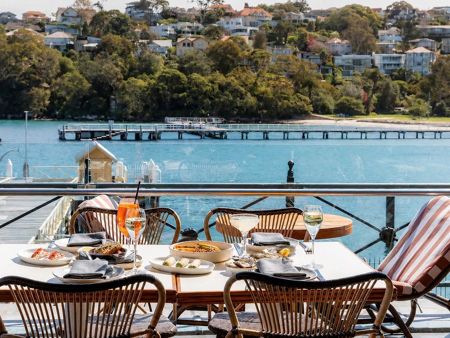 Table set for lunch at a waterfront restaurant overlooking the harbour